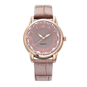 Close-up of diamond-cut glass face and rose gold case on student quartz wrist watch