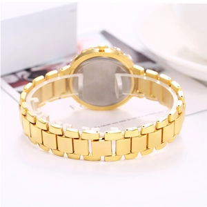 Detail view of a gold fashion watch with diamond bezel and metallic chain strap