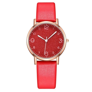 Detail of red leather strap watch with rose gold case and Arabic numeral dial