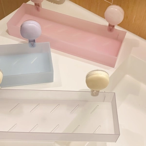 Detail view of colorful suction cup storage racks in pink and blue for bathroom organization