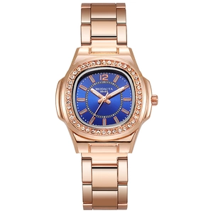 Detail of rose gold ladies watch with blue dial and rhinestone bezel decoration