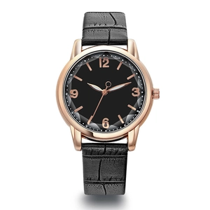 Detail of black dial watch with rose gold case and crocodile pattern leather strap