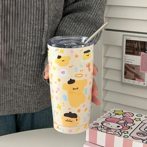 Detail of a beige stainless steel tumbler featuring a cartoon puppy print and metal straw