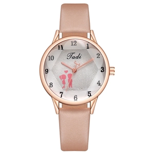 Close-up of pink leather strap watch with rose gold case and faceted glass dial