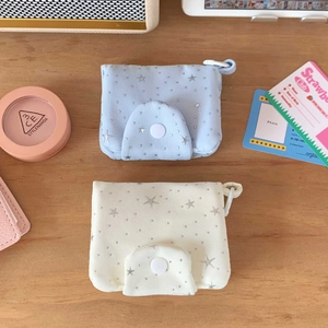 Close-up of star pattern canvas mini pouches with snap button closure on wooden desk