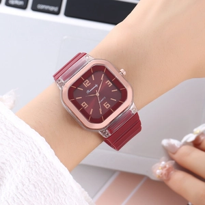 Burgundy minimalist quartz watch with silicone strap on woman wrist in office setting