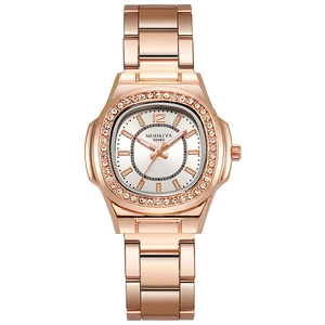 Detail of rose gold rectangular watch face with sparkling double crystal bezel and steel band