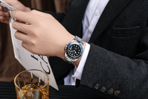 Macro shot of silver quartz watch with luminous hands and date window on male wrist