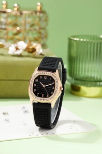 Detail of rose gold quartz watch with rhinestone square case and black dial on green velvet