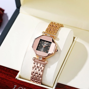 Detail of rose gold octagonal watch with black dial and diamond accents on cushion