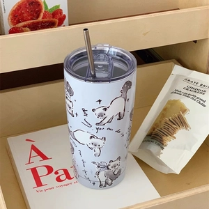 Detail of white 304 stainless steel tumbler with cute cat illustration and metal straw