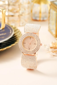 Detailed macro shot of rose gold luxury watch with pavé rhinestones and dot dial