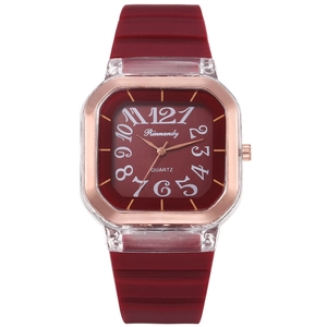 Macro shot of stylish square burgundy watch with rose gold frame and artistic numerals
