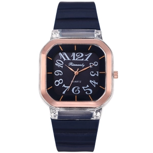 Detail of square quartz watch featuring rose gold bezel and blue ribbed silicone strap