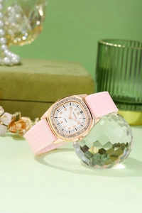 Detailed macro view of the rose gold rhinestone bezel and pink silicone watch strap