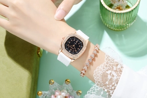 Detail of rose gold square rhinestone watch and heart bracelet set on wrist