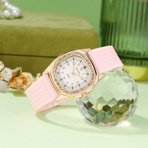 Detail of rose gold diamond watch case with pink silicone strap on crystal