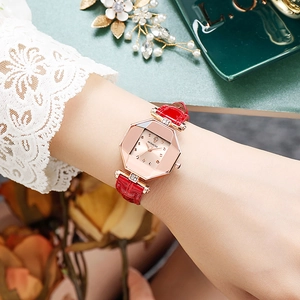 Detail of elegant ladies' watch with malachite green dial and red leather strap