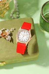 Close-up of a square rhinestone quartz watch on a green velvet jewelry box