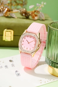 Detail of pink silicone strap watch with rhinestone bezel on luxury jewelry background