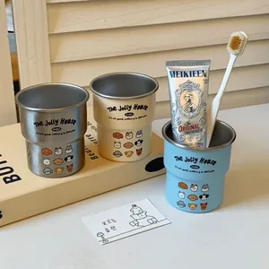 Detailed stack of cartoon dog stainless steel tumblers in beige, blue, and silver colors