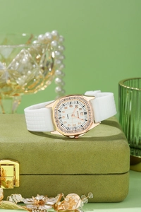 Detail of rose gold square watch with crystal bezel and white silicone strap