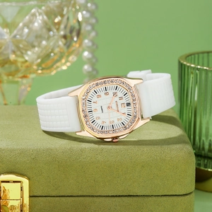 Detail of octagonal watch with crystal bezel and white silicone strap on jewelry box