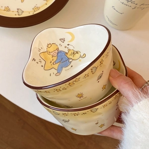 Close-up of heart-shaped ceramic bowls with Little Prince cartoon and stars