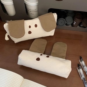 Detail of cute puppy canvas pencil cases with felt ears and embroidered dog faces