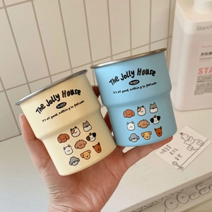 Detail of macaron-colored stainless steel rimmed mugs with cute cartoon dog illustrations