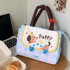 Insulated lunch bag with cute puppy pattern and pink plaid design on a desk