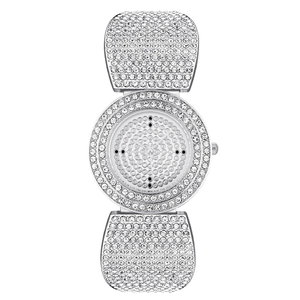 Detail of silver ladies watch featuring round dial and band encrusted with sparkling rhinestones