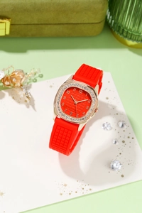 Detail of red quartz watch with sparkling rhinestone bezel and textured silicone strap