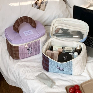 Close-up of large capacity cosmetic bag with purple plaid fabric and dog embroidery detail