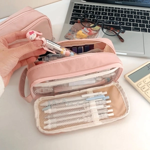 Close-up of pink pencil case interior showing elastic slots and mesh storage compartments