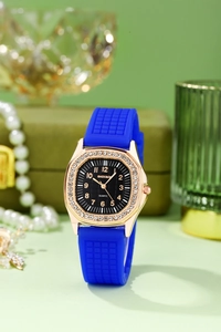 Detail of luxury rose gold square watch with crystal bezel and blue silicone strap