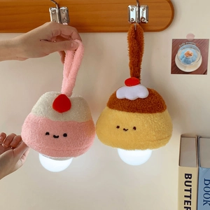 Close-up of cute plush pudding hanging night lights with embroidered faces and soft texture