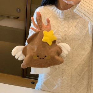 Plush cartoon tissue holder with smiling face, yellow star, and wings in a macro view
