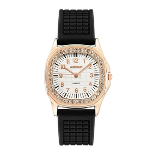 Close-up of rose gold rhinestone bezel and black textured silicone strap watch