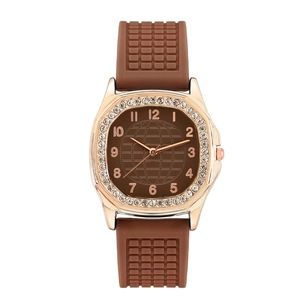 Close-up of rose gold rhinestone bezel and textured brown silicone watch strap