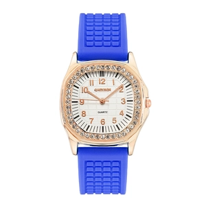 Detail of rose gold square watch with crystal bezel and blue silicone grid strap