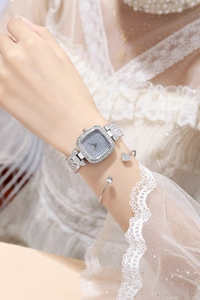 Elegant silver square rhinestone watch for women worn on a delicate lace-sleeved wrist