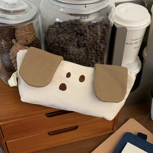 Detailed view of dog-shaped canvas pencil case with cute embroidery and zip closure