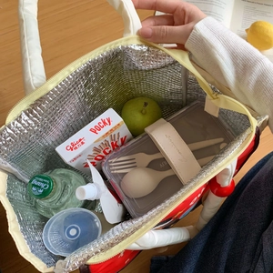 Detail of insulated red lunch bag showing thick aluminum foil lining and spacious interior