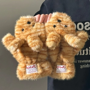Detail of plush orange tabby cat pattern mittens with faux fur texture and brand tag