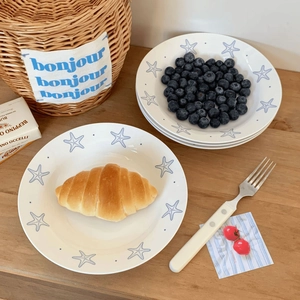 Ceramic starfish dinner plate set for breakfast and desserts on a wooden table