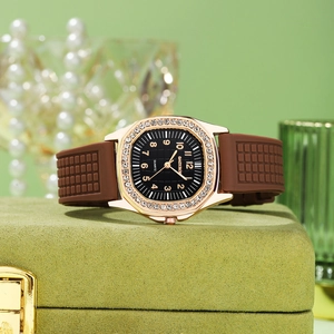 Close-up of square rhinestone watch with rose gold case and brown silicone strap