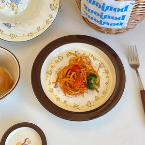 Detailed view of Little Prince ceramic tableware set with star motifs and hand-painted art