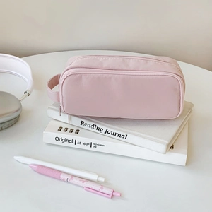 Close-up of pink dual-layer nylon pouch with sturdy handle and high storage capacity
