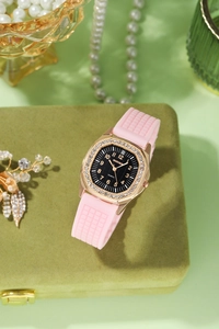 Macro shot of luxury square quartz watch with rose gold rhinestone bezel and pink silicone strap